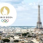 the logo of the olympic games in paris against the background of the eiffel tower